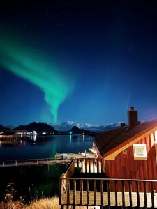 un'immagine dell'aurora boreale sopra un lago di Kræmmervika Havn a Ballstad