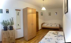 a bedroom with a bed and a cabinet and a bed at Apartment Milkica in Sarajevo