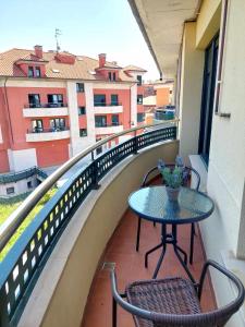 a table and chairs on a balcony with a view at La Marina Posada de LLanes VUT-3648-AS in Posada de Llanes
