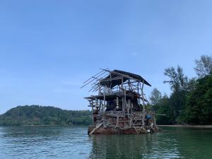 a wooden structure in the middle of the water at Sunset Beach Bungalow Koh Pu in Ko Jum