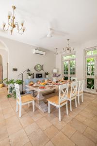 a kitchen and dining room with a table and chairs at LohonoStays Castello Villa 5 in Vagator