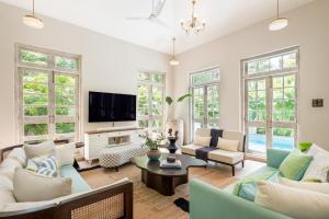 a living room with a couch and a table at LohonoStays Castello Villa 5 in Vagator