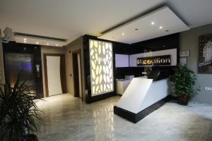 a lobby with a reception desk in a building at Inciler Hotel in Altınoluk