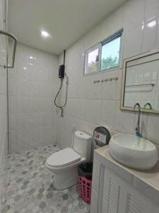 a bathroom with a toilet and a sink at Blanco Beach Bar Hostel in Phi Phi Don