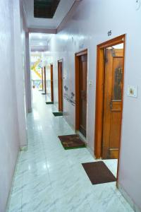 an empty hallway with a row of doors in a building at Hostel shivshakti khajuraho in Khajurāho