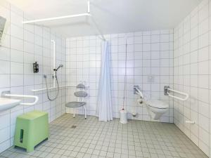 a bathroom with a shower and a sink and a toilet at ETAP Hotel Belfast in Belfast