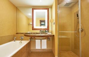 a bathroom with a sink and a tub and a shower at The Westin Warsaw in Warsaw