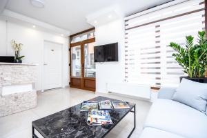 a living room with a white couch and a table at Guesthouse Bebek in Sarajevo