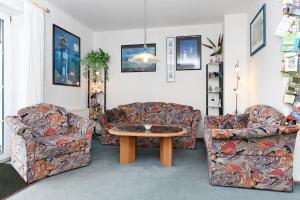 uma sala de estar com dois sofás e uma mesa em Ferienhaus Dat Krebs Huus em Dornumersiel