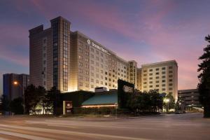a hotel building with a parking lot in front of it at DoubleTree by Hilton Chicago O'Hare Airport-Rosemont in Rosemont