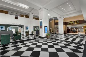 a lobby with a black and white checkered floor at DoubleTree by Hilton Chicago O'Hare Airport-Rosemont in Rosemont