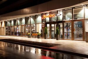 a store front of a shopping mall at night at Hampton By Hilton Munich City Center East in Munich