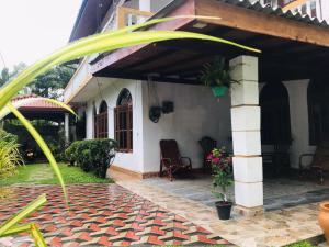 a porch of a house with a patio at Surewo Sun Shine Apartment in Bentota