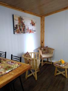 a living room with wooden tables and chairs at Tiny House Melgarejo in San Carlos de Bariloche