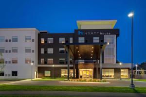 a night view of a hotel building with a light house at Hyatt House Mall Of America Msp Airport in Bloomington