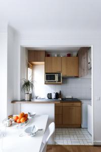 a kitchen with a table with oranges on it at Paris 15eme - Porte de versailles - Vaugirard in Paris