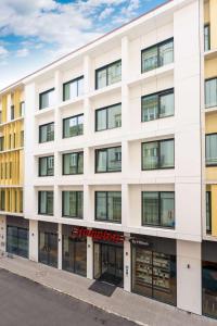 an apartment building with a white facade at Hampton By Hilton Budapest City Centre in Budapest