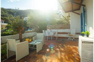 a patio with a table and chairs and the sun at Silva in Campese +5 photos