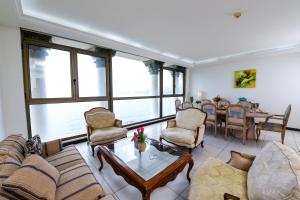 a living room filled with furniture and a table at Portaluna Hotel & Resort in Jounieh