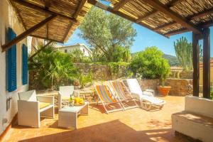 a patio with lounge chairs and a table at Silva in Campese
