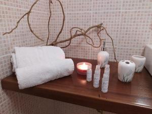 a wooden table with towels and candles on it at Casa Silius in Silìus +20 photos