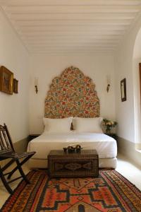 Postel nebo postele na pokoji v ubytování Riad El Morocco Hotel