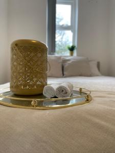 a gold container on a bed with two towels at Manchester City luxury hideaway in Urmston