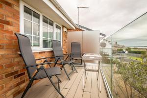 a patio with chairs and a table on a balcony at Pass the Keys Stunning waterside retreat with estuary views in Exeter