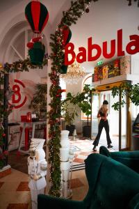 Una mujer caminando por una tienda con adornos navideños en Hotel Babula am Augarten, en Viena