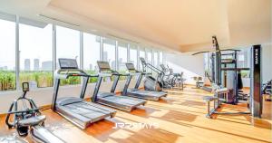 a gym with rows of treadmills and elliptical machines at JRR Stays - JVC Bloom Tower B 605 Amazing Studio Sleeps 2 in Dubai