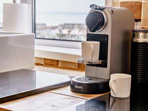 a coffee machine sitting on a counter with a cup at 3 bed in Dale 45361 in Dale