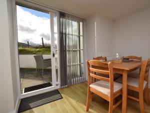 a dining room with a table and a sliding glass door at 1 Bed in Morebattle 52538 in Morebattle