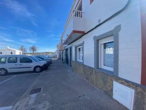 a parking lot with cars parked next to a building at Apartamento en Na Macaret B in Na Macaret