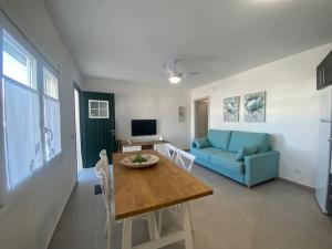 a living room with a blue couch and a table at Apartamento en Na Macaret B in Na Macaret