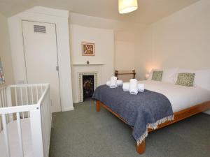 a bedroom with a bed and a fireplace at 4 bed in Lyndhurst 57407 in Lyndhurst