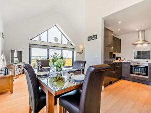 a kitchen and dining room with a table and chairs at 2 bed in Lizard 47283 in Ruan Major