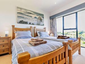 a bedroom with two beds and a large window at 2 bed in Lizard 47283 in Ruan Major