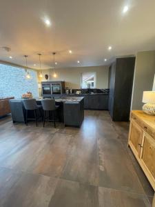a large kitchen with a table and chairs at Pendle View by Valley View Lodges in Longridge