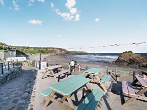 a group of picnic tables on the beach at 2 bed in Lizard 47283 in Ruan Major