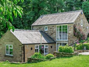 a small stone house with a large window at 1 Bed in Barlow 40971 in Chesterfield