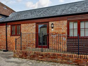 a brick building with a red door and a fence at 2 Bed in Taunton KIBSH in Trull