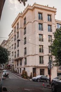 a large white building with cars parked in front of it at Lord Morgan & Exclusive Design Cihangir in Istanbul