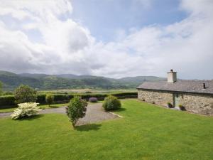 an external view of a stone house with a green lawn at 2 bed in Conwy Valley SKN09 in Llanrwst