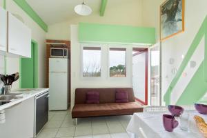 a kitchen with a couch in front of a window at Bidart - balcon - Proche plage in Bidart
