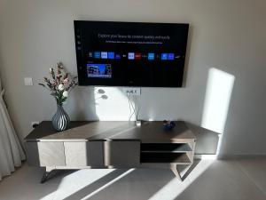 a entertainment center with a tv on a wall at Samanthas LUXURY APARTMENT in Haraki