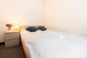 Postel nebo postele na pokoji v ubytování 鶴橋妙宅