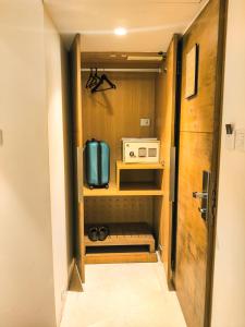 Habitación pequeña con cocina con microondas. en Ramee Guestline Hotel Khar, en Bombay