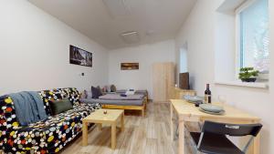 a living room with a couch and a table at Apartmán Esser 5 in Milovice