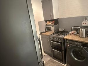 a kitchen with a stove and a washing machine at Double room to rent 2 in Birmingham