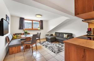 a living room with a couch and a table at Pension Zum Rechen in Bodenmais